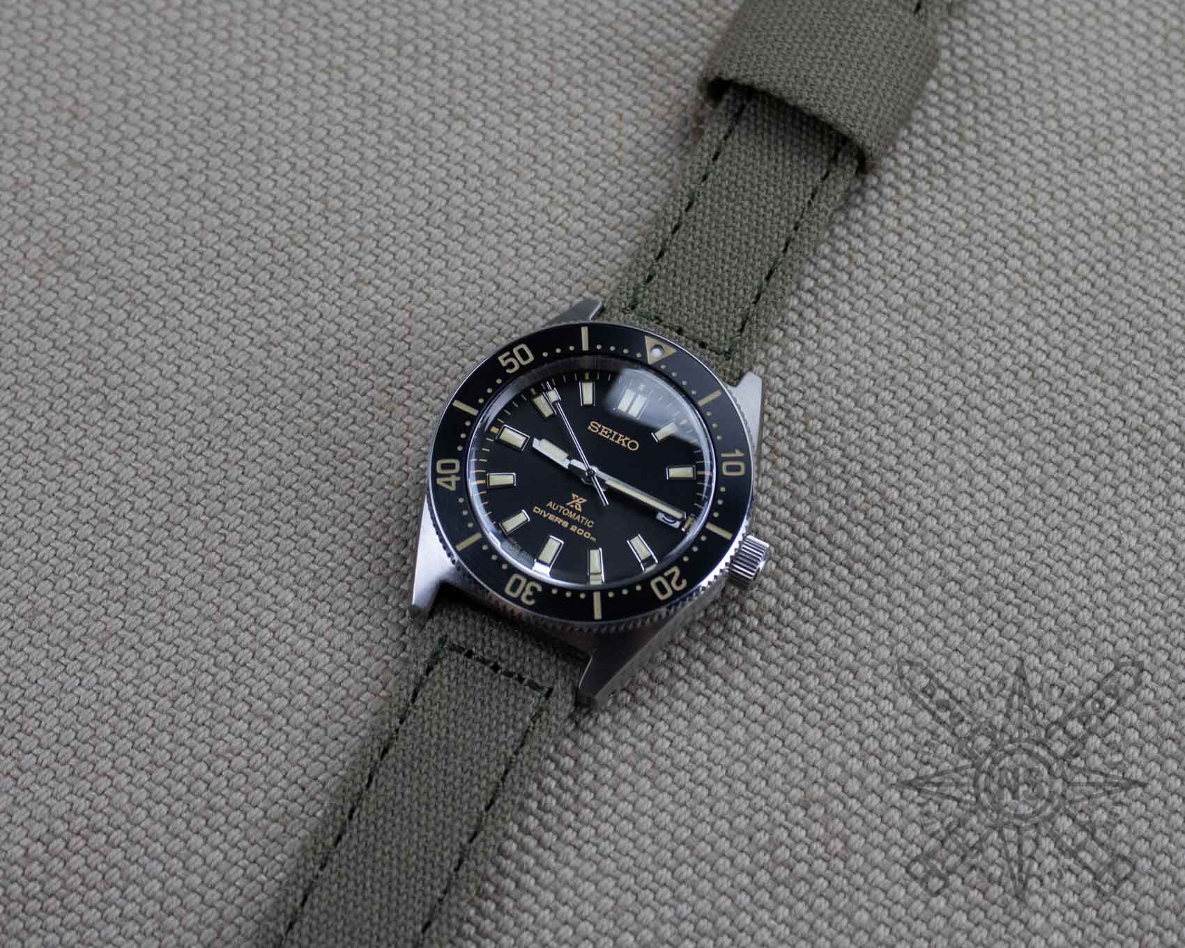 Khaki green canvas watch strap on a Seiko dive watch