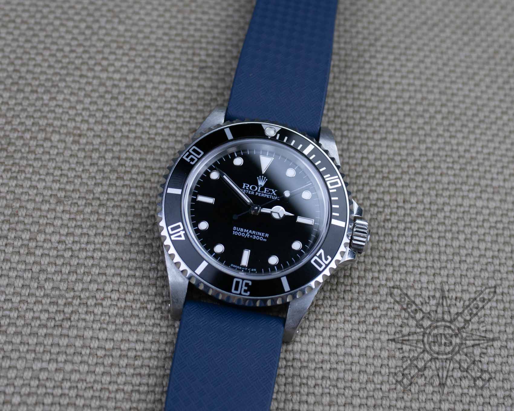 Navy blue rubber watch strap on a Rolex Submariner