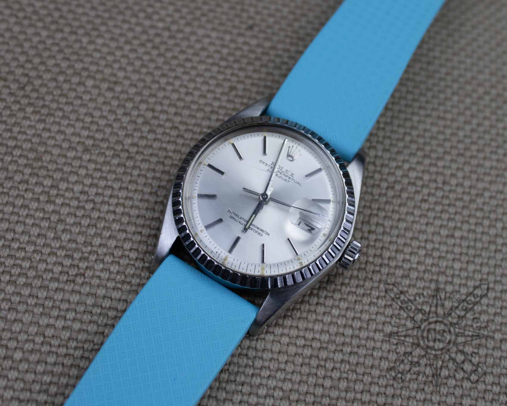 Blue rubber watch strap on a Rolex Datejust