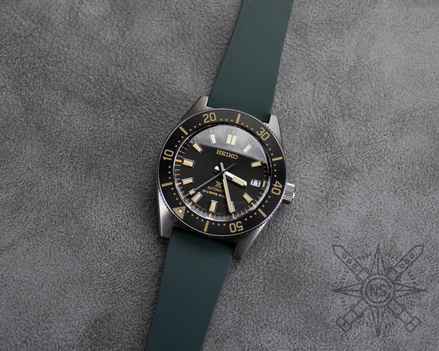 Green rubber watch strap on a seiko dive watch