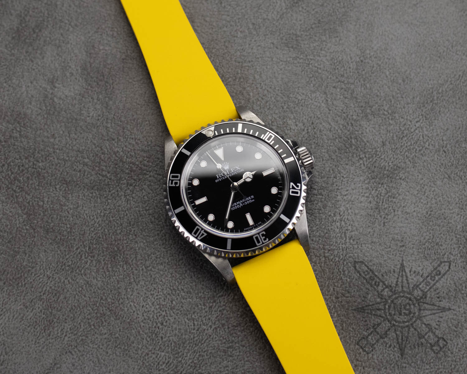 Yellow rubber watch strap on a Rolex Submariner