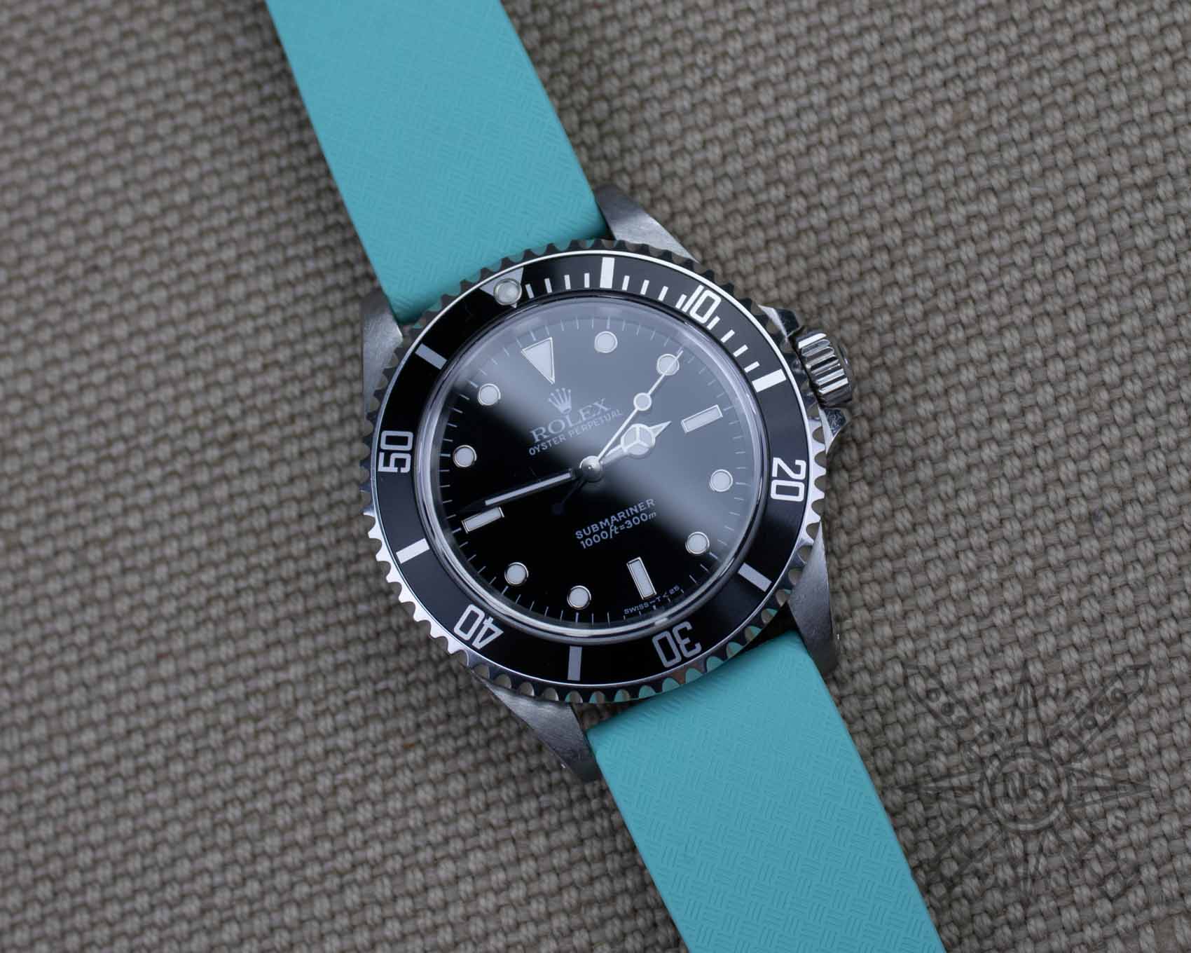 Rolex Submariner on a teal blue rubber watch strap