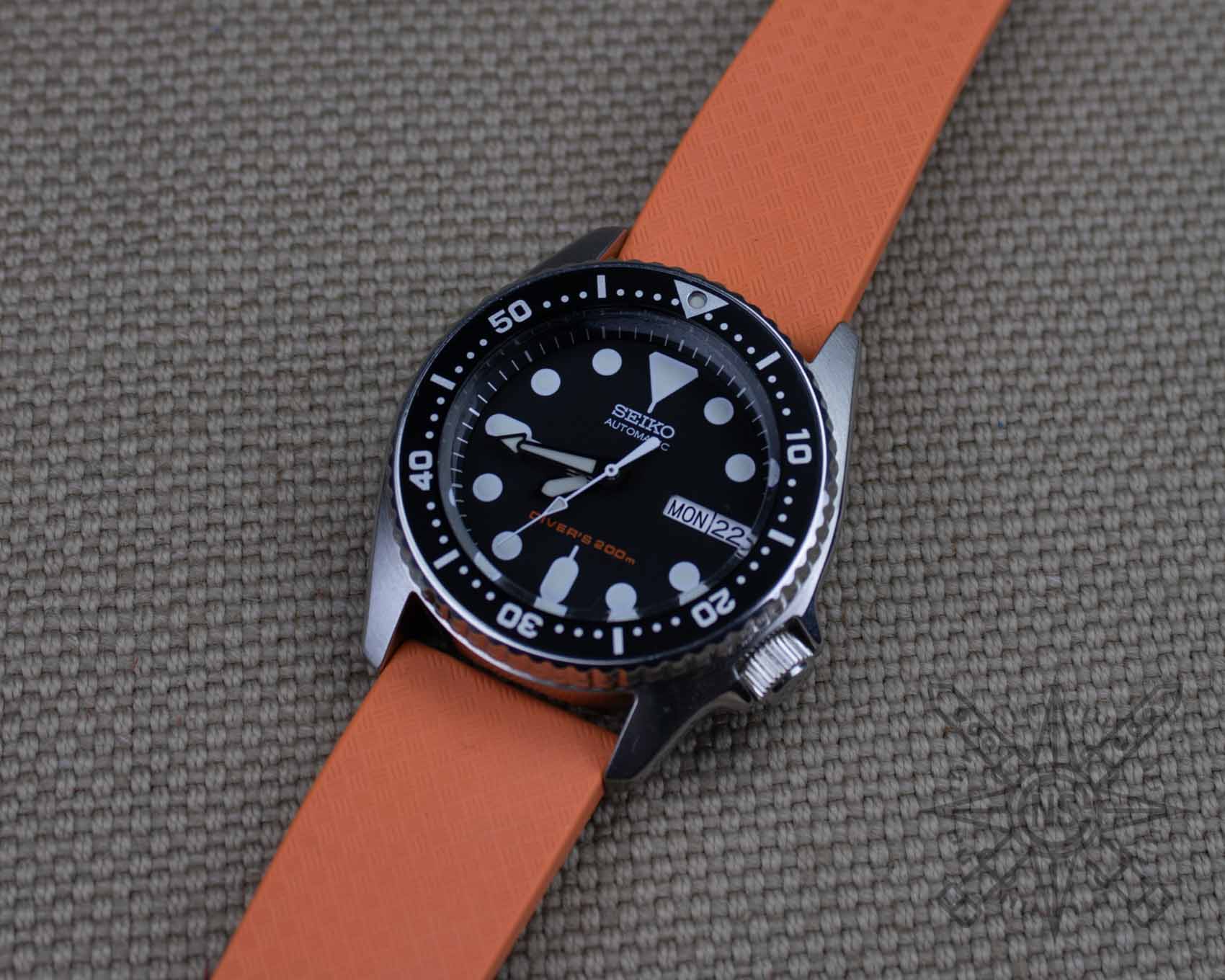 Orange rubber watch strap on a seiko diver