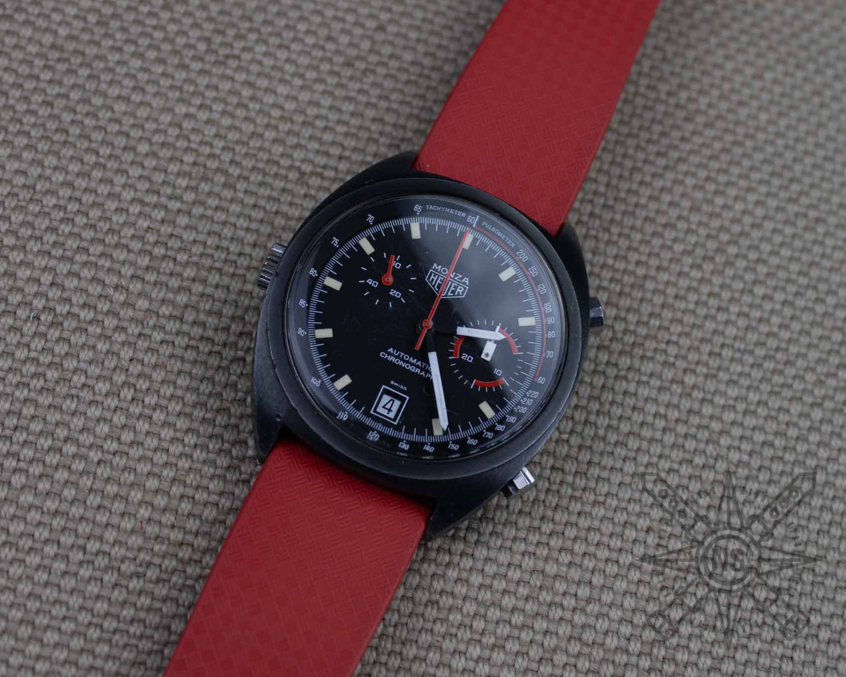 Red rubber watch strap on a vintage Heuer