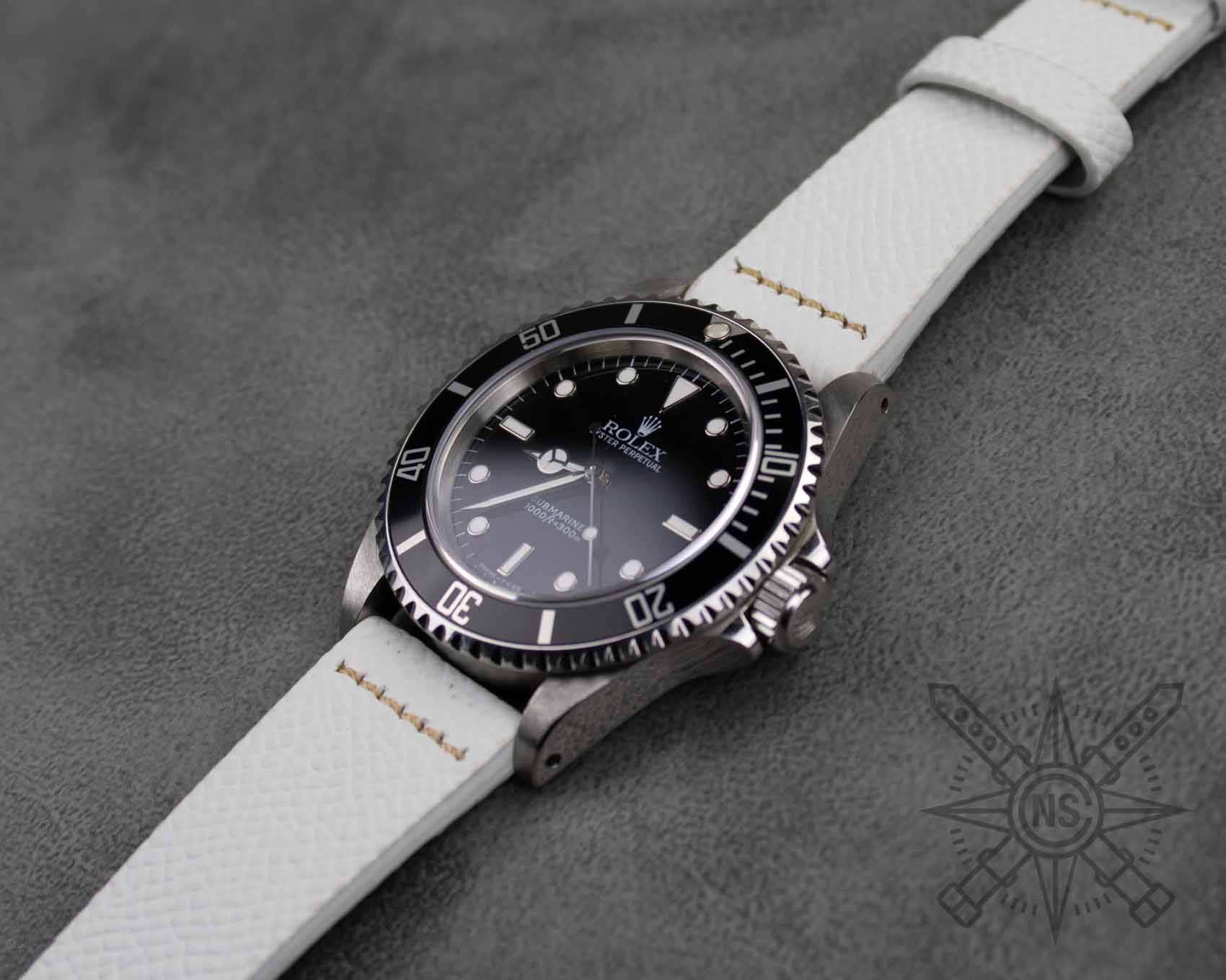 Row-stitched white leather watch band on Rolex Submariner