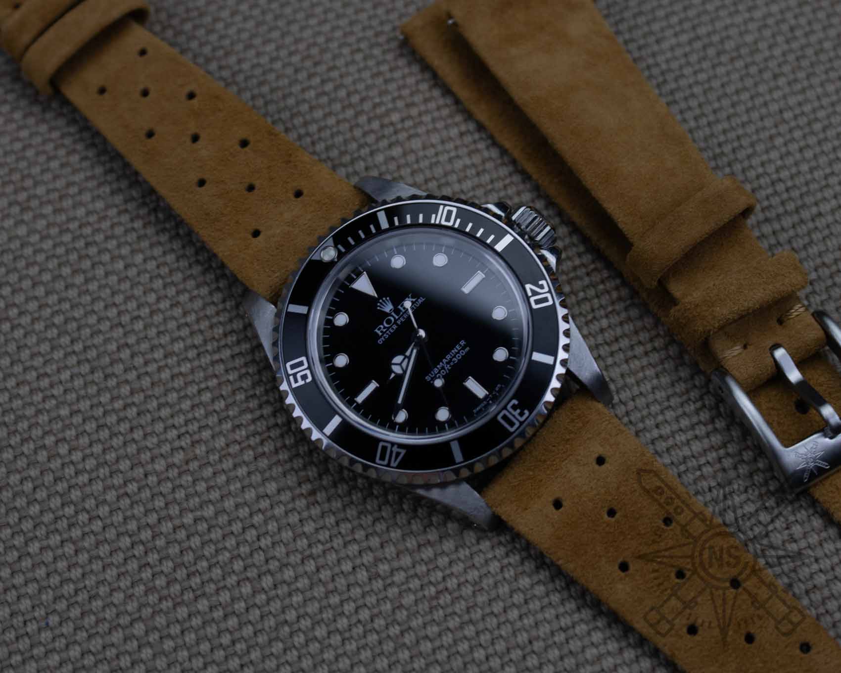 Rolex Submariner on a suede racing watch band