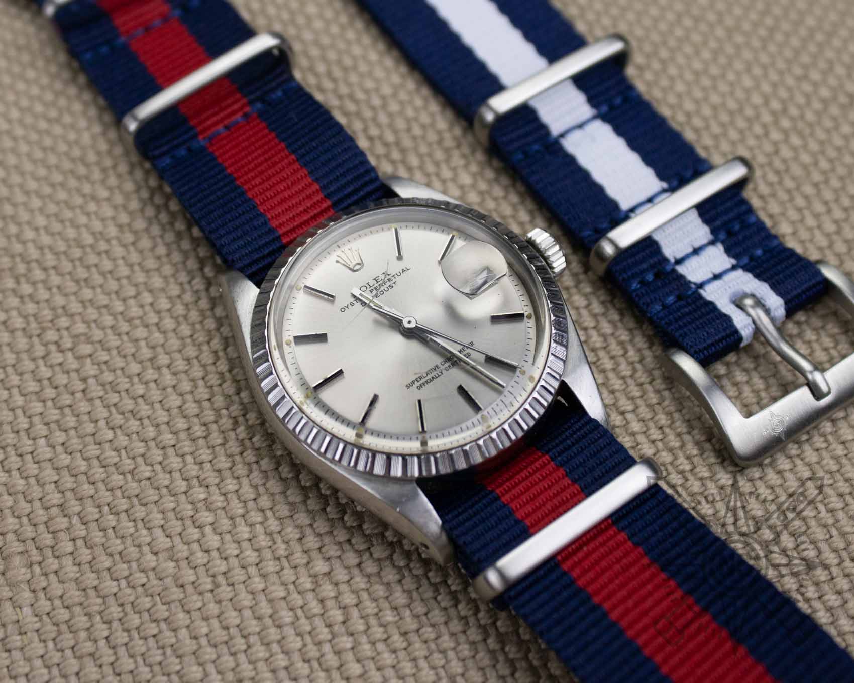 Blue and red watch strap on a Rolex Datejust