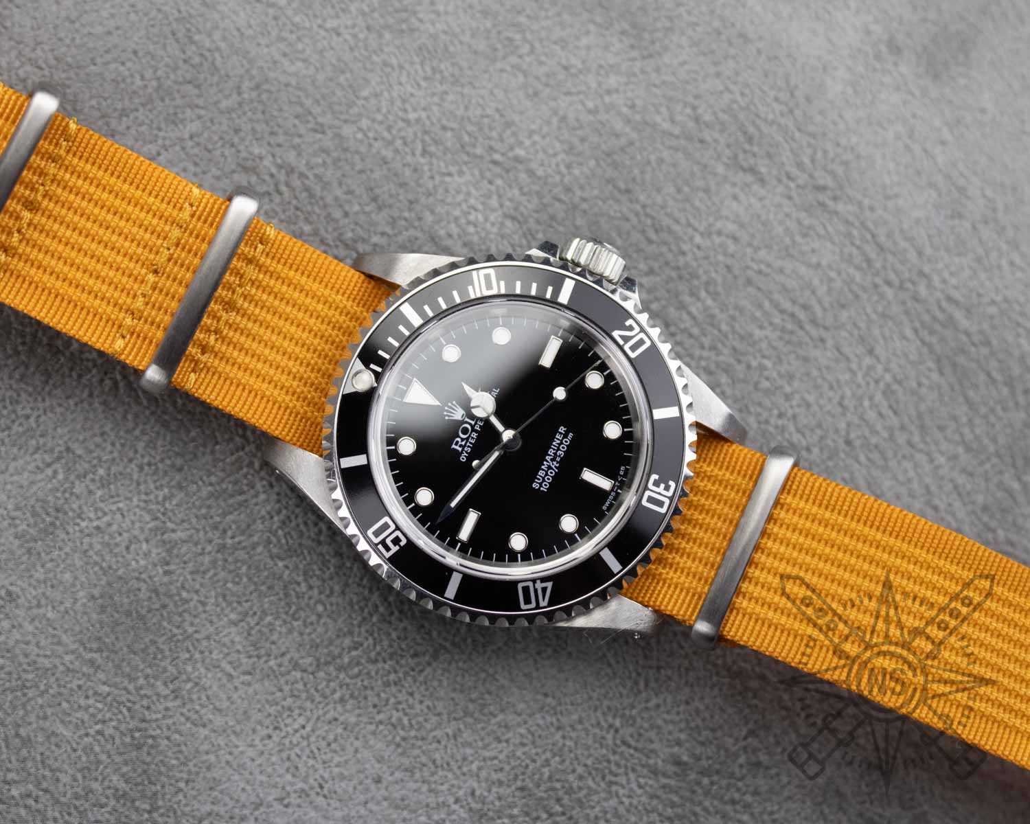 Orange ribbed watch straps on a Rolex Submariner