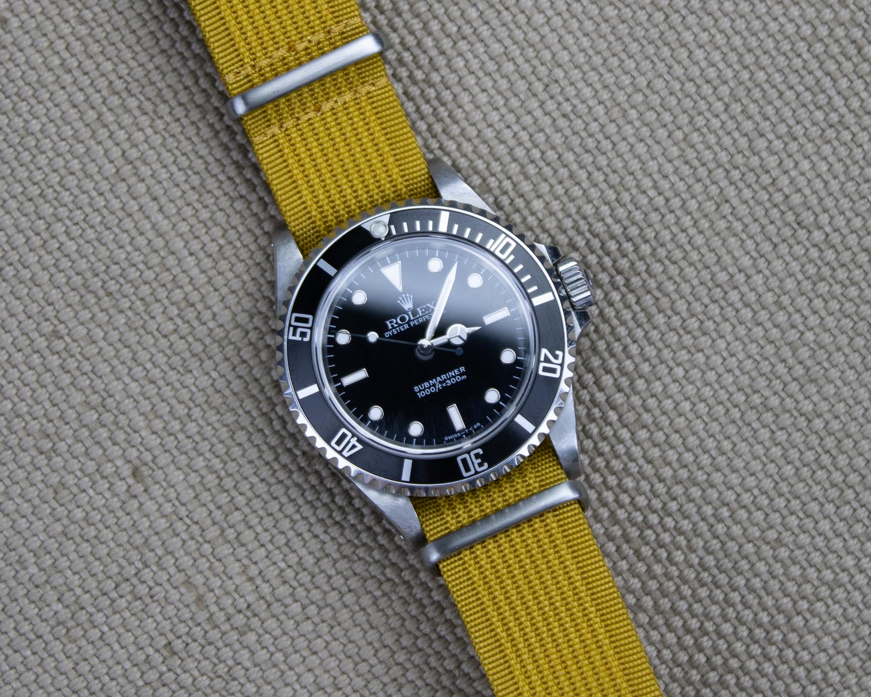 Mustard yellow ribbed nylon watch strap on a Rolex Submariner