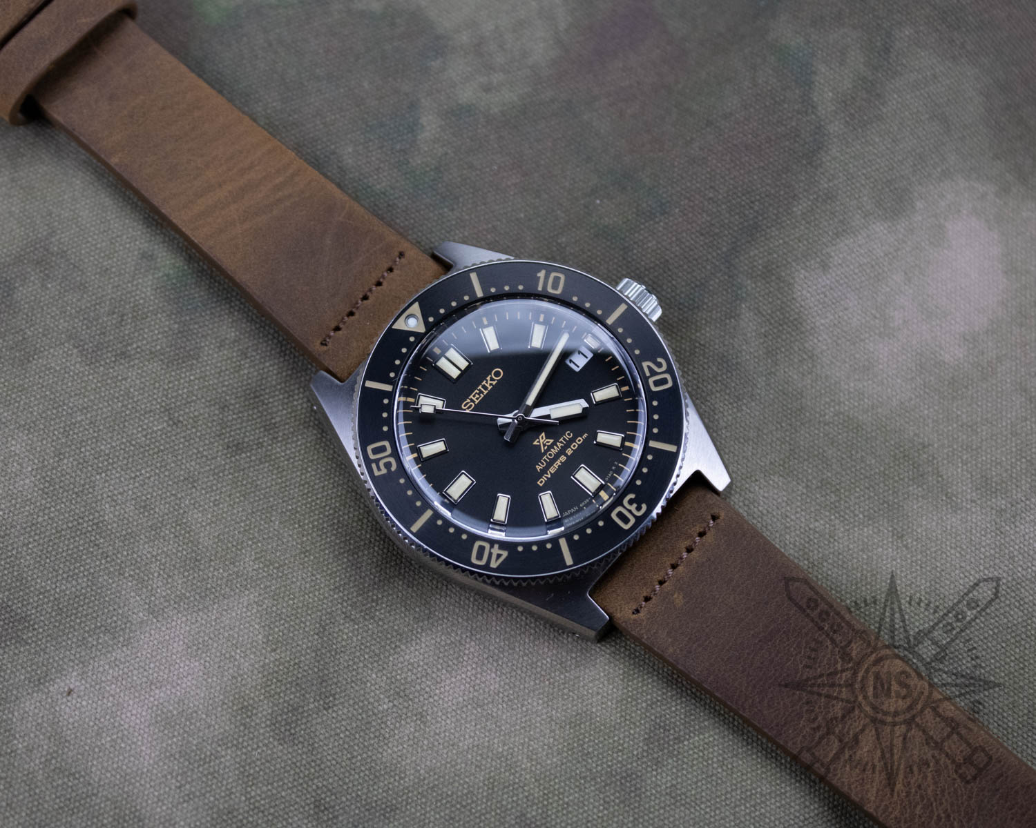 Row-stitched brown leather watch band on a seiko dive watch