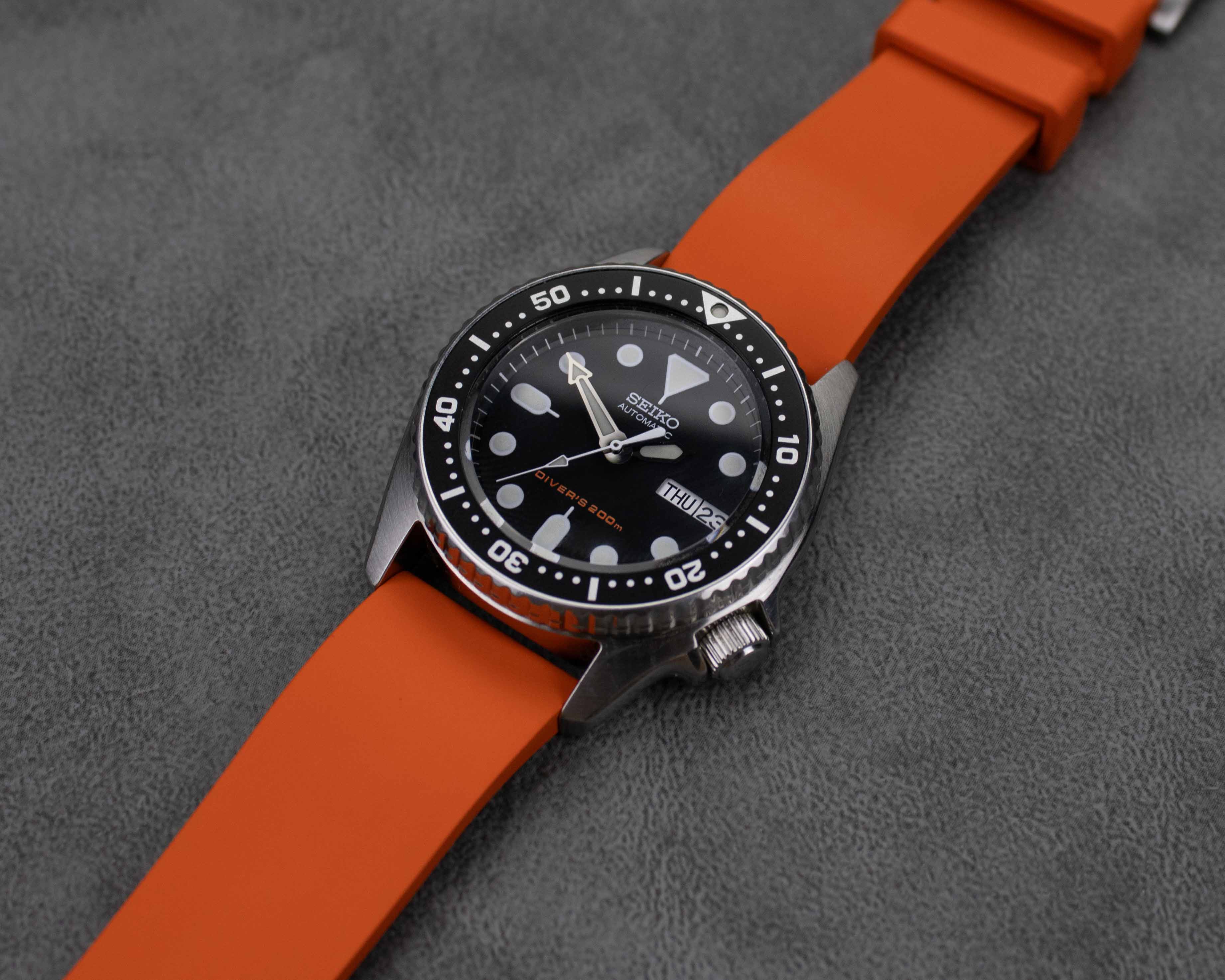 Orange rubber watch strap on a Seiko dive watch