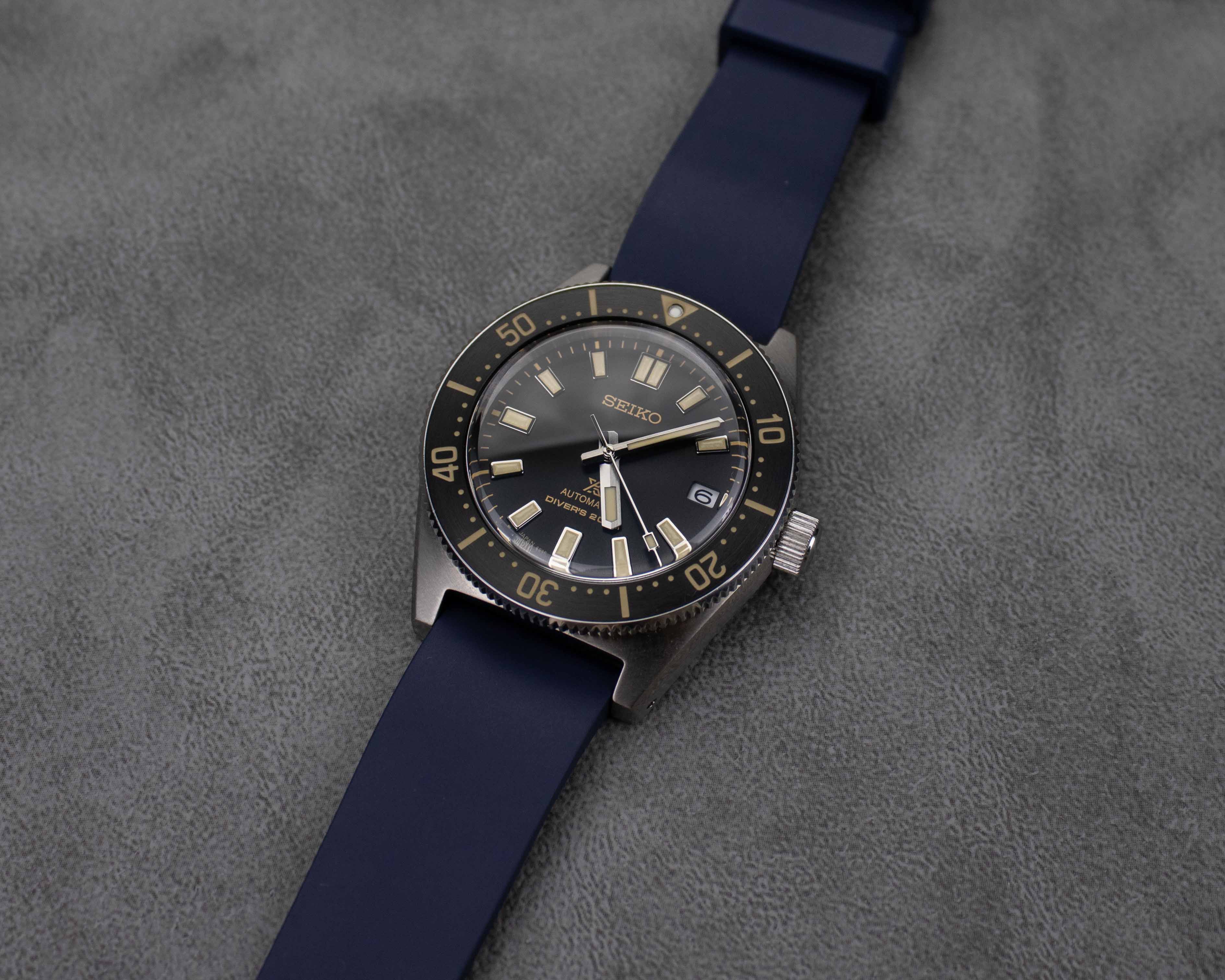 Navy blue rubber watch strap on a Seiko dive watch