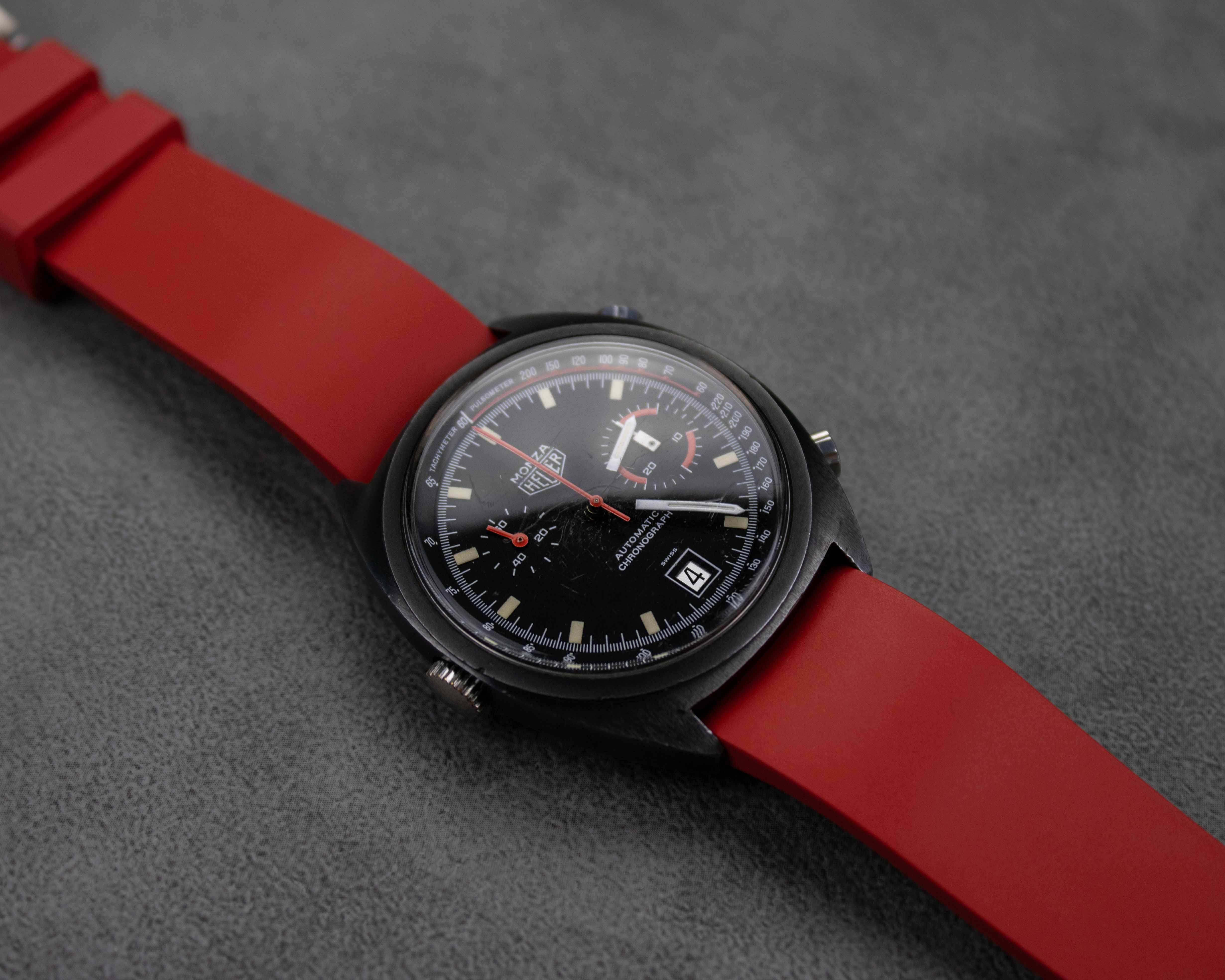 Red rubber watch strap on a vintage Heuer chronograph