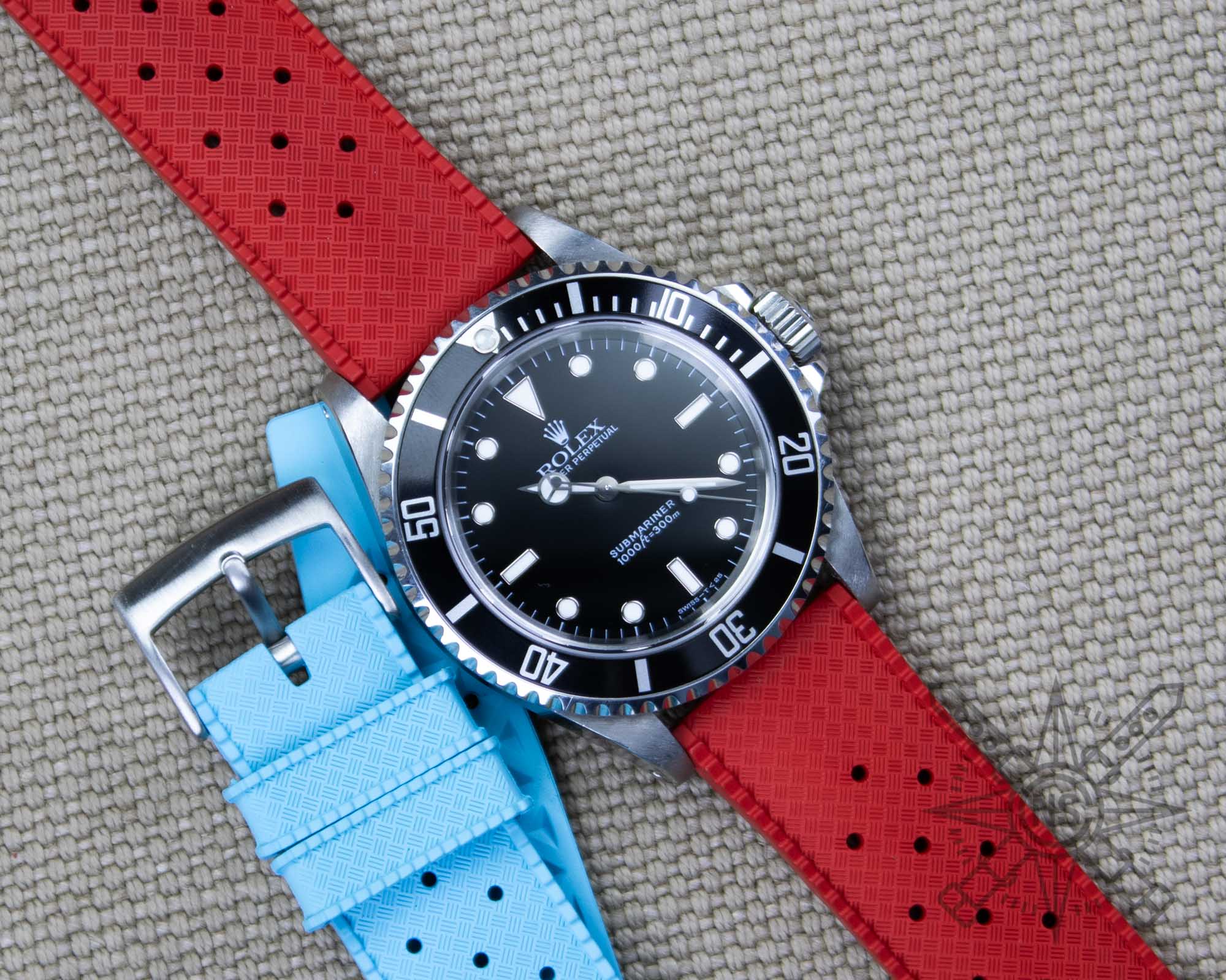 Red tropic rubber watch strap on a Rolex Submariner