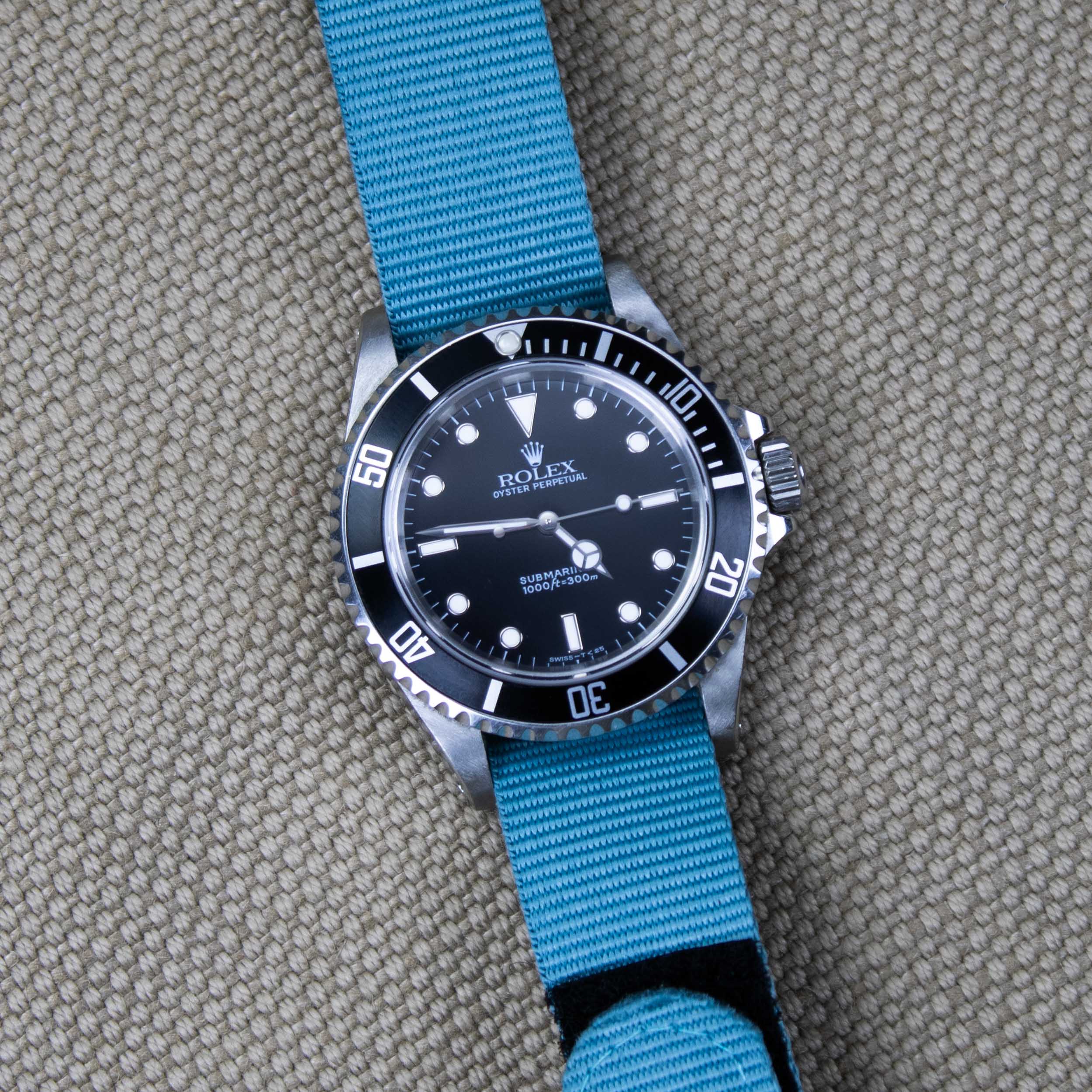 Rolex Submariner on a petrol blue velcro watch band