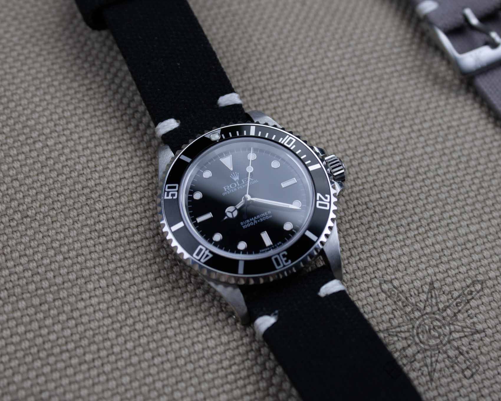 Black canvas watch strap on a Rolex Submariner